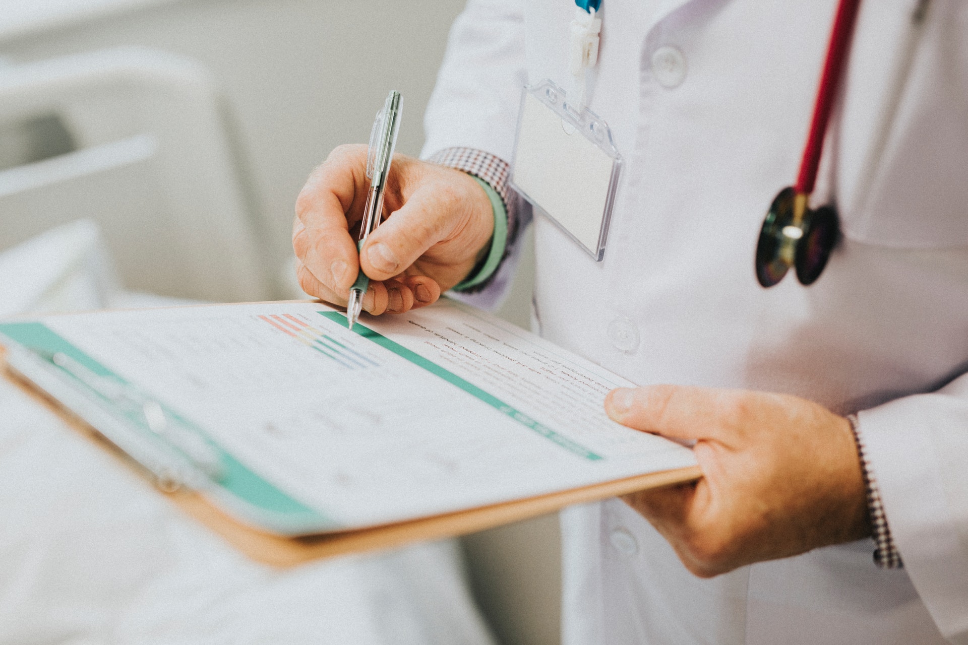 doctor holding clip board taking personal info